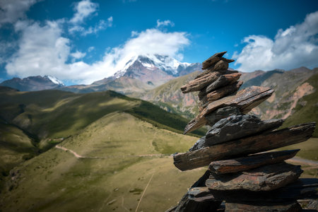 Mountain ranges on a sunny day in Georgia. Sky with clouds adn hills. tower of stonesの写真素材