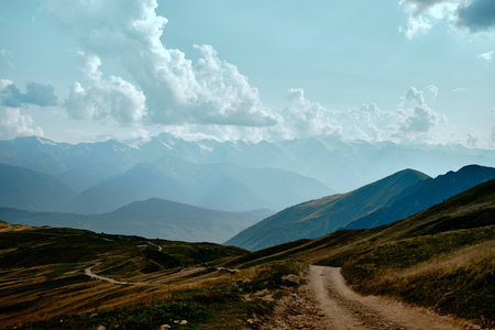 Mountain ranges on a sunny day at Georgia. Sky with clouds adn hills