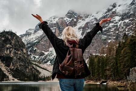 Mountain lake Braies in Italy. Girl in front of the lake looks at the beautiful landscapeの写真素材