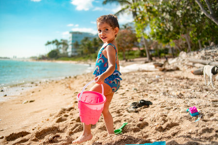 Adorable little girl playing with toys on the beach. Summer vacation conceptの写真素材