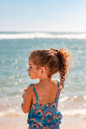 Cute little girl on the beach at the day time.の写真素材
