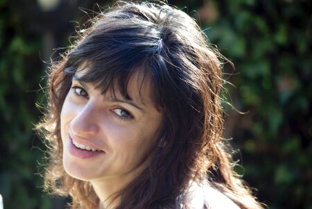 girl with big eyes smiling outdoorsの写真素材