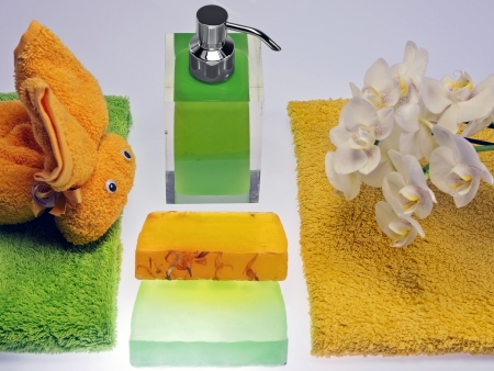 wash skin with colored soap dispenser and towelsの写真素材