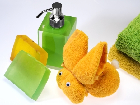wash skin with colored soap dispenser and towelsの写真素材