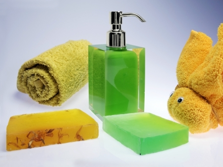 wash skin with colored soap dispenser and towelsの写真素材