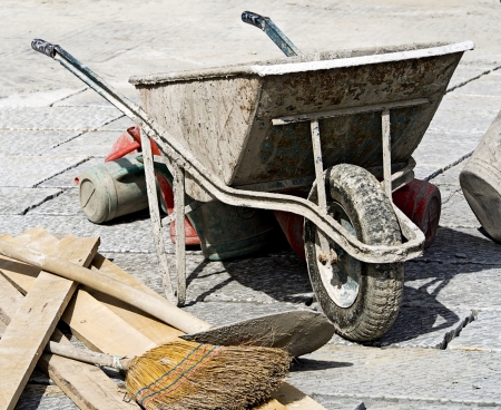 paving work with wheelbarrow bucket and broomの写真素材