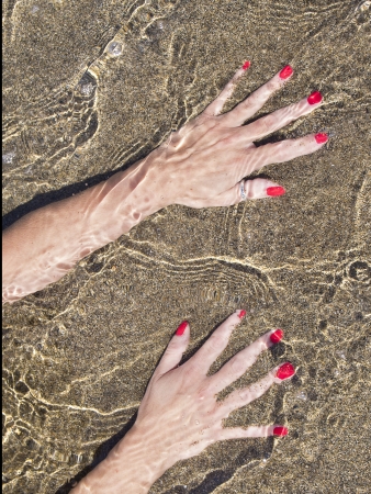 woman hands on the water foreshore,  black sand
の写真素材