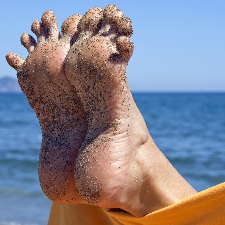 sandy crazy woman toes  moving and relaxing on the beachの写真素材