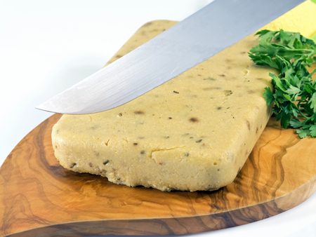 corn polenta and porcini mushrooms cut in slices with a knifeの写真素材