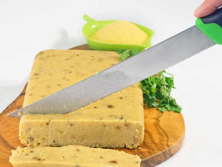 corn polenta and porcini mushrooms cut in slices with a knifeの写真素材