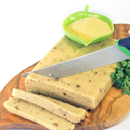 corn polenta and porcini mushrooms cut in slices with a knifeの写真素材