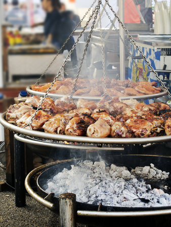 roasted pork knuckle  on  large brazier in country fairの写真素材