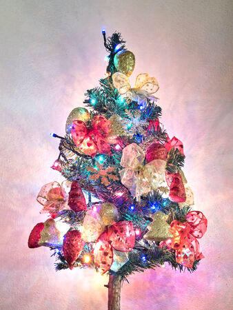 Christmas tree with decorations and lights onの写真素材
