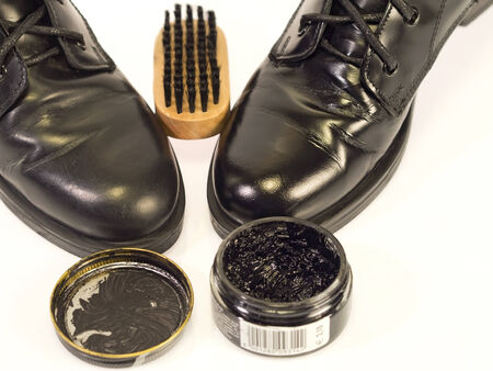 the  kit to polish black shoes,   polish and brush, white backgroundの写真素材