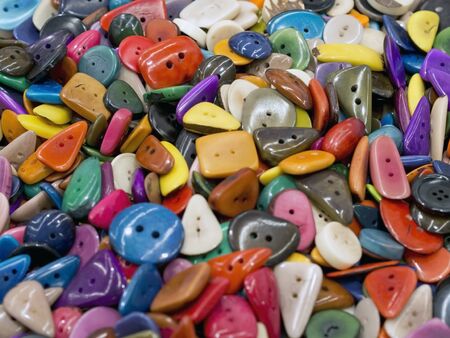 many irregular colored buttons of various shapes  on each otherの写真素材