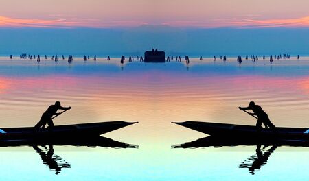 Venice sunset symmetrical silhouette of sinchronized rowing menの写真素材