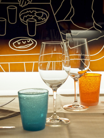 glasses and colored glasses in a bistro for a romantic dateの写真素材