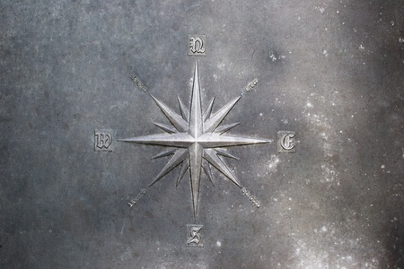 The wind rose,Compass rose engraved on the metalの写真素材
