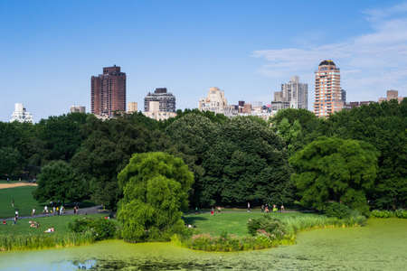 New York City, USA - August 3, 2013 view of some skyscrapers from one of the many lakes found in central park in new york people come here to relax and practice outdoor sportsのeditorial素材
