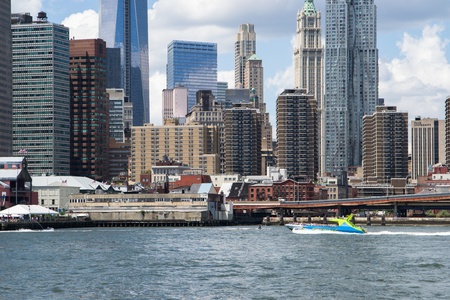 New York City, USA - August 4,2013 manhattan skyline view from brooklyn bridge park boats carry tourists on the hudson river to admire the skylineのeditorial素材
