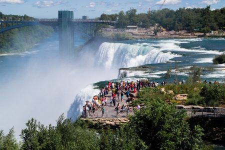 niagra Falls, USA - august 10, 2013 people and tourists admire the falls on the American side from one of the many places of scenic path in a sunny dayのeditorial素材
