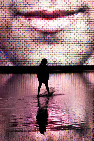 a silhouette of a girl in front of the crown fountain at nightの写真素材