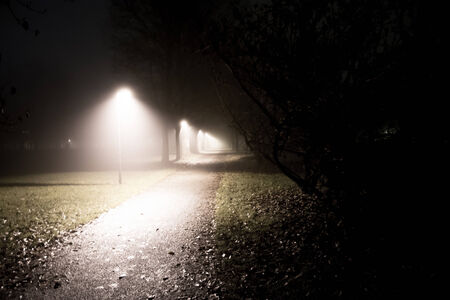 a little road lost in the fog at night timeの写真素材