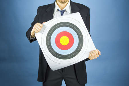 business man holding a target in front of youの写真素材