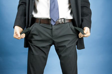 businessman showing empty pockets in pantsの写真素材