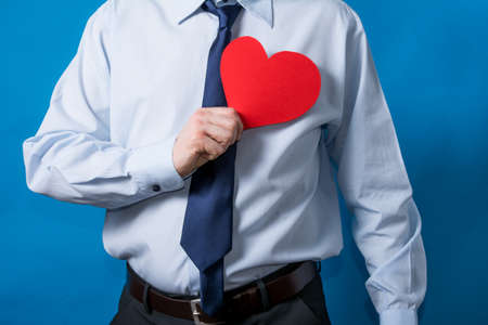 man shows a red heart in loveの写真素材
