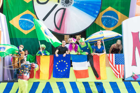 san Giovanni in persiceto,Bologna,Italy-march 9,2014 carnival masks surrounded by many colorful flags of nationsのeditorial素材