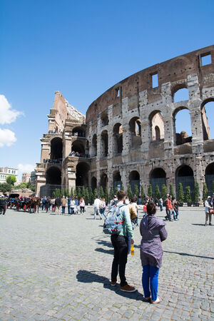 rome,italy-April 17,2014 tourists admire the coliseum in the centre of ancient rome in a sunny dayのeditorial素材