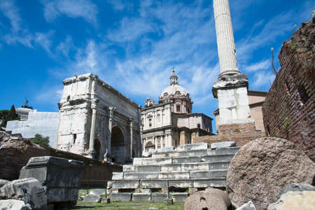 tourists stroll admiring the majesty of the Roman Forum in a sunny day in Romeの写真素材