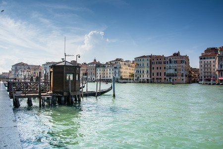 one of the many boat moorings in Venice grand canal during a sunny dayの写真素材