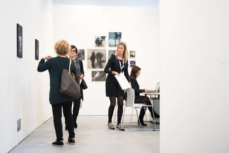 Bologna,Italy-January 24,2015:people walk and look at works of art in an exhibition while art experts answer all questions related to the artists on display.のeditorial素材