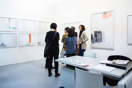 Bologna,Italy-January 24,2015:people walk and look at works of art in an exhibition while art experts answer all questions related to the artists on display.のeditorial素材