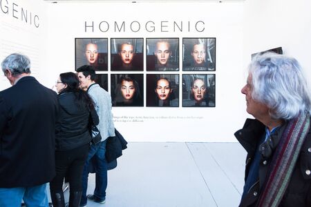 Bologna,Italy-January 24,2015:people walk and look at works of art in an exhibition while art experts answer all questions related to the artists on display.のeditorial素材