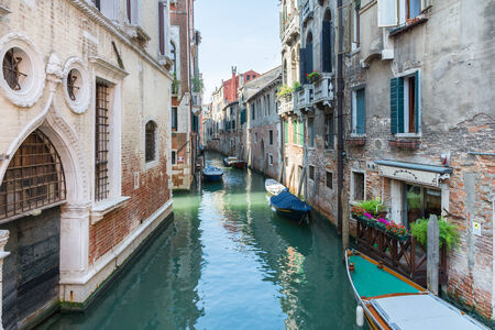 Venice,Italy-August 12,2014:commercial and touring boats navigate the canals of Venice during a summer day.This is one of  hidden corner of Venice.のeditorial素材