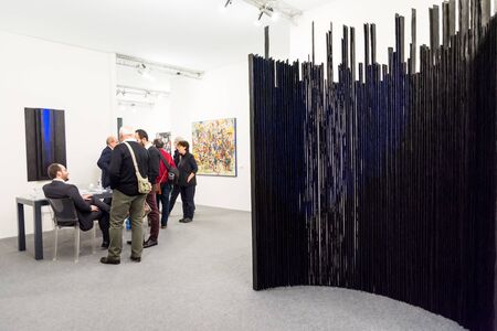 Bologna, Italy-January 24.2015: people walk and look at works of art in an art exhibition while experts answer all questions related to the artists on display.のeditorial素材