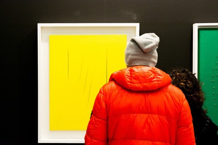 Bologna, Italy-January 24.2015: people walk and look at works of art in an art exhibition while experts answer all questions related to the artists on display.のeditorial素材