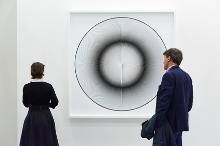 Bologna,Italy-January 24,2015:people walk and look at works of art in an exhibition while art experts answer all questions related to the artists on display.のeditorial素材