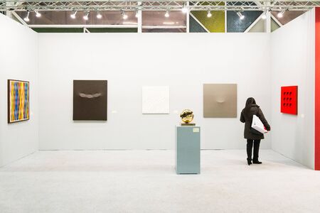 Bologna,Italy-January 24,2015:people walk and look at works of art in an exhibition while art experts answer all questions related to the artists on display.のeditorial素材
