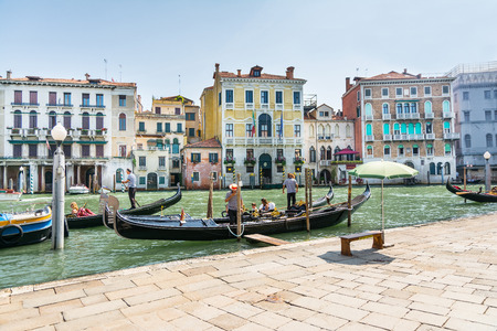Venice,Italy-August 12,2014:Venetian gondoliers await some tourists to carry around on a gondola in Venice During a sunny day.のeditorial素材