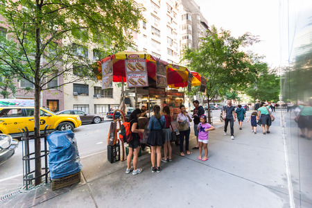 New York City, USA - August 3, 2013:People queuing at a characteristic fast food hot dog stand near the museum of modern art in new york..This fast food mobile stands are very popular all over Manhattan.のeditorial素材