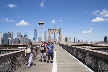 New York City, USA - August 4.2013: Tourists and New Yorkers cross the bridge brooklin During a sunny day.This bridge is one of the main tourist attractions of Manhattan.のeditorial素材