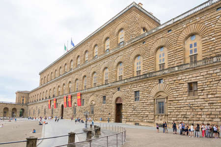 Florence, Italy-August 26.2014: Tourists walking around and waiting outside the Pitti Palace Pitti Palace During a cloudy day. The Palazzo Pitti is one of the landmarks in Florence and the point of access to the Boboli's gardens.のeditorial素材