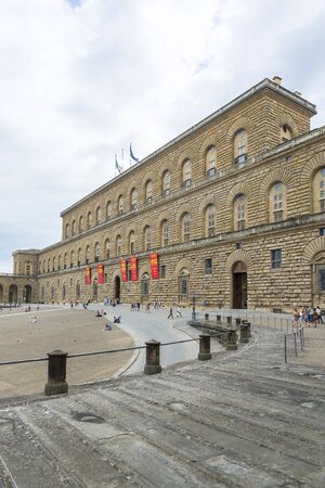 Florence, Italy-August 26.2014: Tourists walking around and waiting outside the Pitti Palace Pitti Palace During a cloudy day. The Palazzo Pitti is one of the landmarks in Florence and the point of access to the Boboli's gardens.のeditorial素材