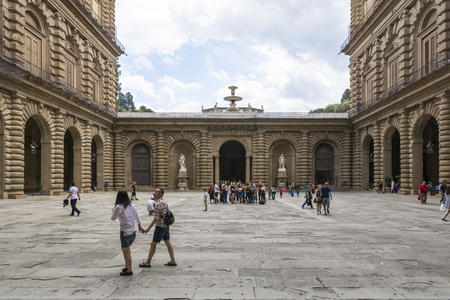 Florence, Italy-August 26.2014: Tourists walking around and waiting outside the Pitti Palace Pitti Palace During a cloudy day. The Palazzo Pitti is one of the landmarks in Florence and the point of access to the Boboli's gardens.のeditorial素材