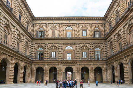 Florence, Italy-August 26.2014: Tourists walking around and waiting outside the Pitti Palace Pitti Palace During a cloudy day. The Palazzo Pitti is one of the landmarks in Florence and the point of access to the Boboli's gardens.のeditorial素材