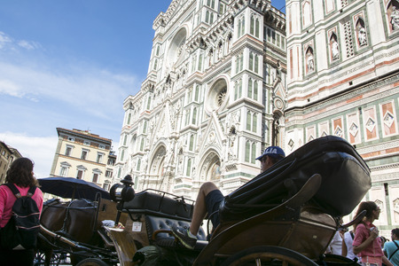 Florence,Italy-august 26,2014:Cab driver waiting for tourists to take a walk in front of the Cathedral of Santa Maria del Fiore in Italy During a sunny day.のeditorial素材